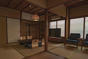 a rendering of a living room with a tv and chairs at CraftFlat Asakusa House in Tokyo