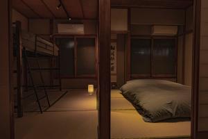 a room with two bunk beds and a lamp at CraftFlat Asakusa House in Tokyo
