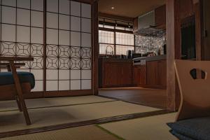 a room with a kitchen with a table and a mirror at CraftFlat Asakusa House in Tokyo