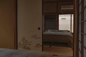 a bedroom with a bunk bed and a mirror at CraftFlat Asakusa House in Tokyo