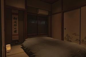 a bedroom with a bed and a window at CraftFlat Asakusa House in Tokyo