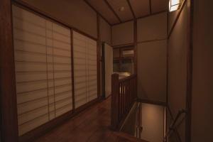 a room with a hallway with a wooden floor and a mirror at CraftFlat Asakusa House in Tokyo