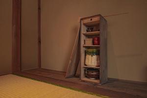 a small cabinet in the corner of a room at CraftFlat Asakusa House in Tokyo