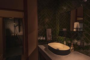 a bathroom with a sink and a shower at CraftFlat Asakusa House in Tokyo