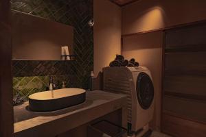 a bathroom with a sink and a washing machine at CraftFlat Asakusa House in Tokyo +30 photos