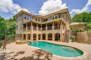 a large house with a swimming pool in front of it at The Bayberry Retreat in Gainesville