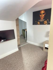 a living room with a flat screen tv on a wall at Milennium Apart Hotel in Bucharest