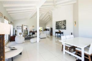 a white living room with a white table and chairs at Artiko Luxury Suites - Jan Thiel in Jan Thiel +67 photos