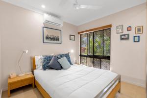 a bedroom with a large bed and a window at 3-Bed Family Home with Pool & BBQ by the Beach in Clifton Beach