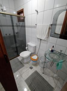 a bathroom with a toilet and a sink and a shower at Pousada Bonamigos in Santa Teresa