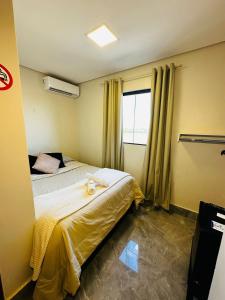 a hotel room with two beds and a window at Riacho Hotel in Brasília
