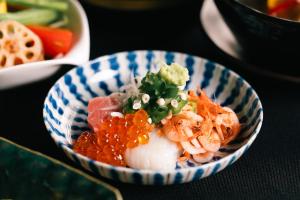 a blue and white bowl of food with shrimp and vegetables at Boscage Kariya in Yugawara