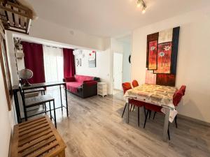 a living room with a table and a couch at Apartsalou Priorat in Salou
