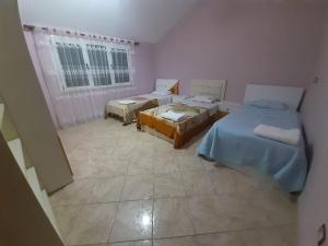 a room with two beds and a window at Villas Eleni for rent best view in Xhafzotaj