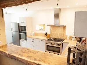 a kitchen with white appliances and a wooden counter top at Gîte spacieux à Happonvilliers avec jardin privatif, accueil jusqu'à 14 personnes, animaux admis - FR-1-581-139 in Happonvilliers +27 photos
