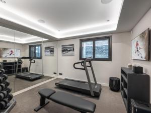 a fitness room with a treadmill and a gym at Chalet de Luxe avec Piscine, Sauna, Salle de Sport et Cinéma - FR-1-569-194 in Megève