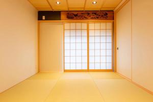 an empty room with a large window in a room at 三十三Tuchi in Kyoto