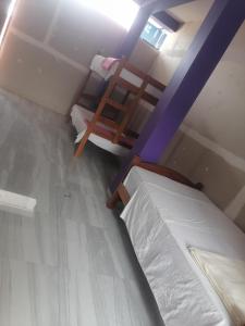 Postel nebo postele na pokoji v ubytování Ayahuasca Hostel