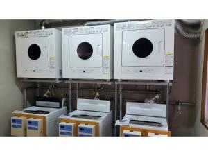 a group of microwaves and appliances on a shelf at Nobeoka Urban-Hotel - Vacation STAY 30459v in Nobeoka