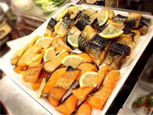 a plate of food with lemon slices on it at Nobeoka Urban-Hotel - Vacation STAY 30534v in Nobeoka +39 photos