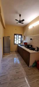 a kitchen with a refrigerator and a counter top at 2bhk apartment baga with kitchen in North goa