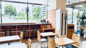 a restaurant with tables and chairs and a bar at Toyoko Inn Saitama Shintoshin in Saitama