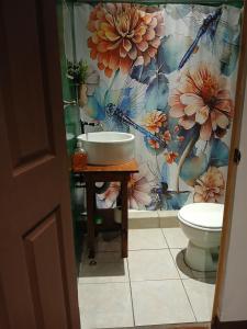 a bathroom with a sink and a toilet at Hotel La Xinca in Antigua Guatemala