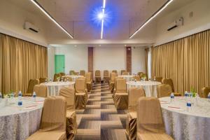 a banquet hall with tables and chairs and a room filled with tables and chairsktop at Mango Hill Pondicherry in Puducherry +66 photos