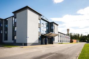 an empty street in front of a building at Sports Hotel in Valmiera