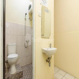 a bathroom with a toilet and a sink at Pulogadung Residence by Nam RedPartner in Jakarta +20 photos