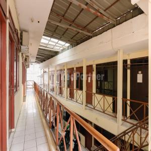 an empty hallway of a building with windows at Pulogadung Residence by Nam RedPartner in Jakarta