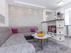 a living room with a couch and a tv at Apartment Moja - Two Bedroom Apartment with Terrace in Zaton Doli