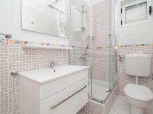 a bathroom with a sink and a toilet and a shower at Apartments Antonio - Comfort One-Bedroom Apartment with Balcony and Sea View - 4 in Tučepi +7 photos