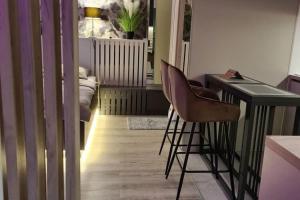 a kitchen with a desk and two chairs in a room at Studio apartment with terrace in Varazdin in Varaždin +8 photos