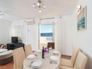 a dining room with a table and a view of the ocean at Apartment Stipic Omis - Three Bedroom Apartment with Terrace in Omiš