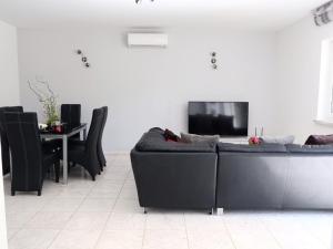 a living room with a couch and a table at Villa Tonika -Two Bedroom Apartment with Terrace A1 in Povlja