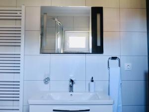 a white bathroom with a sink and a mirror at Villa Tonika -Two Bedroom Apartment with Terrace A1 in Povlja +10 photos