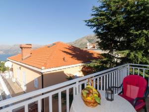 a basket of fruit sitting on a table on a balcony at Apartments Senjo - Studio Apartment with Balcony and Sea View Apartman 2 in Cavtat