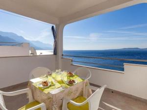 a dining room with a table and a view of the ocean at Apartments Nena ST - One Bedroom Apartment with Balcony and Sea View A1 in Pisak