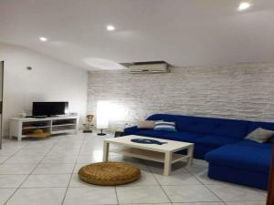 a living room with a blue couch and a table at Apartment Barbara - Two Bedroom apartment with Terrace in Vir