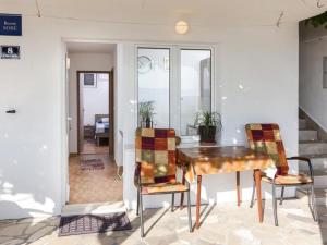 ein Esszimmer mit einem Tisch und zwei Stühlen in der Unterkunft Apartments Stipo - One Bedroom Apartment with Terrace and Sea View A4 in Drače + 9 Fotos