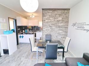 a dining room with a table and chairs and a kitchen at Apartment Marjana Prizba with terrace in Prizba