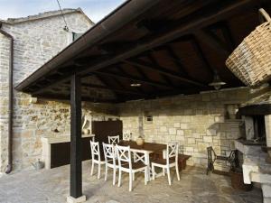 Un patio con una mesa y sillas de madera. en Villa Dol-Three Bedroom Villa with Pool, en Postira