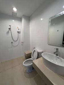 a bathroom with a toilet and a sink and a shower at Rawai Sea Beach in Phuket