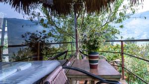 a table and chairs on a balcony with a view at Eco Hills Homestay in Sapa