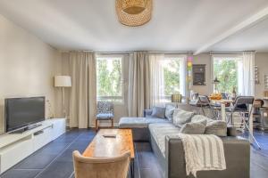 a living room with a couch and a tv at Bel appartement Bordeaux centre in Bordeaux