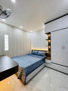 a bedroom with a bed and a large cabinet at Thạch Đà Motel in Ho Chi Minh City