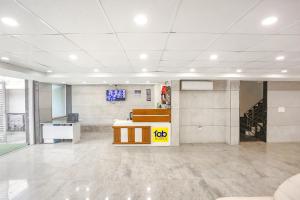 an empty office with a desk in a large room at FabHotel Aerosky - Nr Yashobhoomi Convention Centre in New Delhi