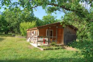 a tiny house in a field with a person standing outside at Lagrange Grand Bleu Vacances - Residence Les Ségalières in Gramat
