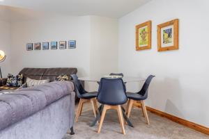 a living room with a couch and three chairs at Hunters Glebe Country Apartment in Castlerock